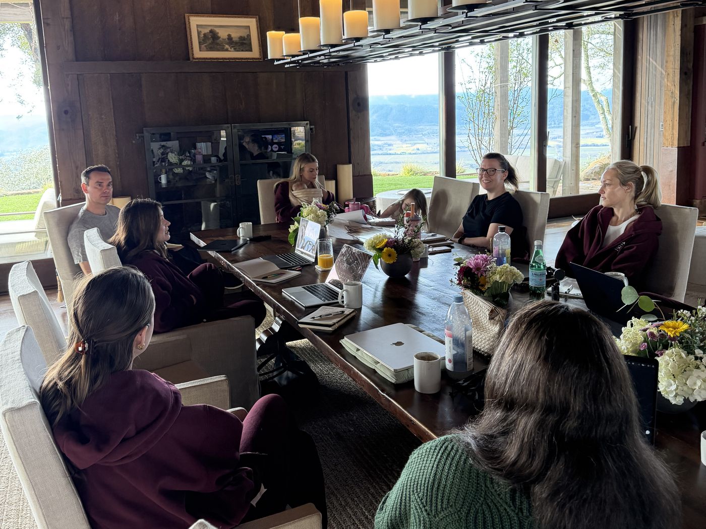 The Bossbabe team meeting around a long wooden table